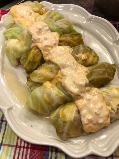 cabbage rolls with thousand island dressing on top